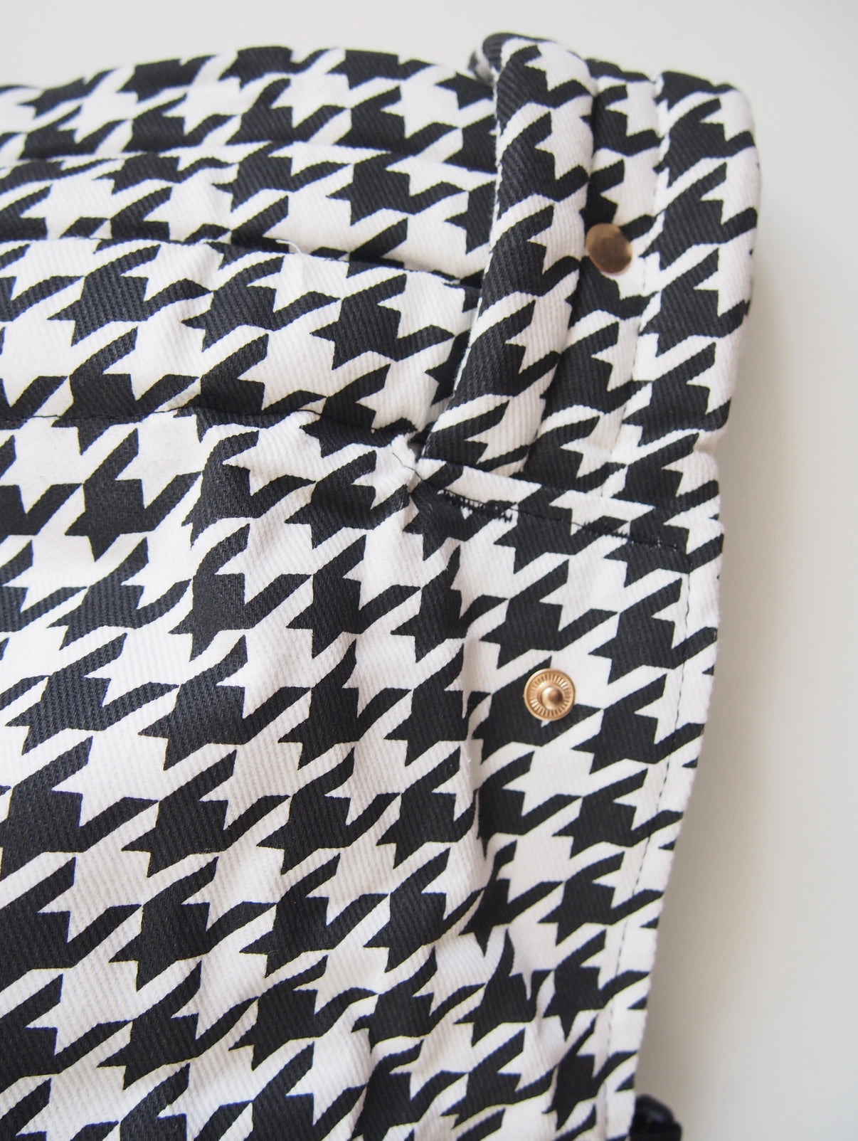 Black houndstooth ergonomic baby carrier back view - soft-structured carrier with adjustable straps