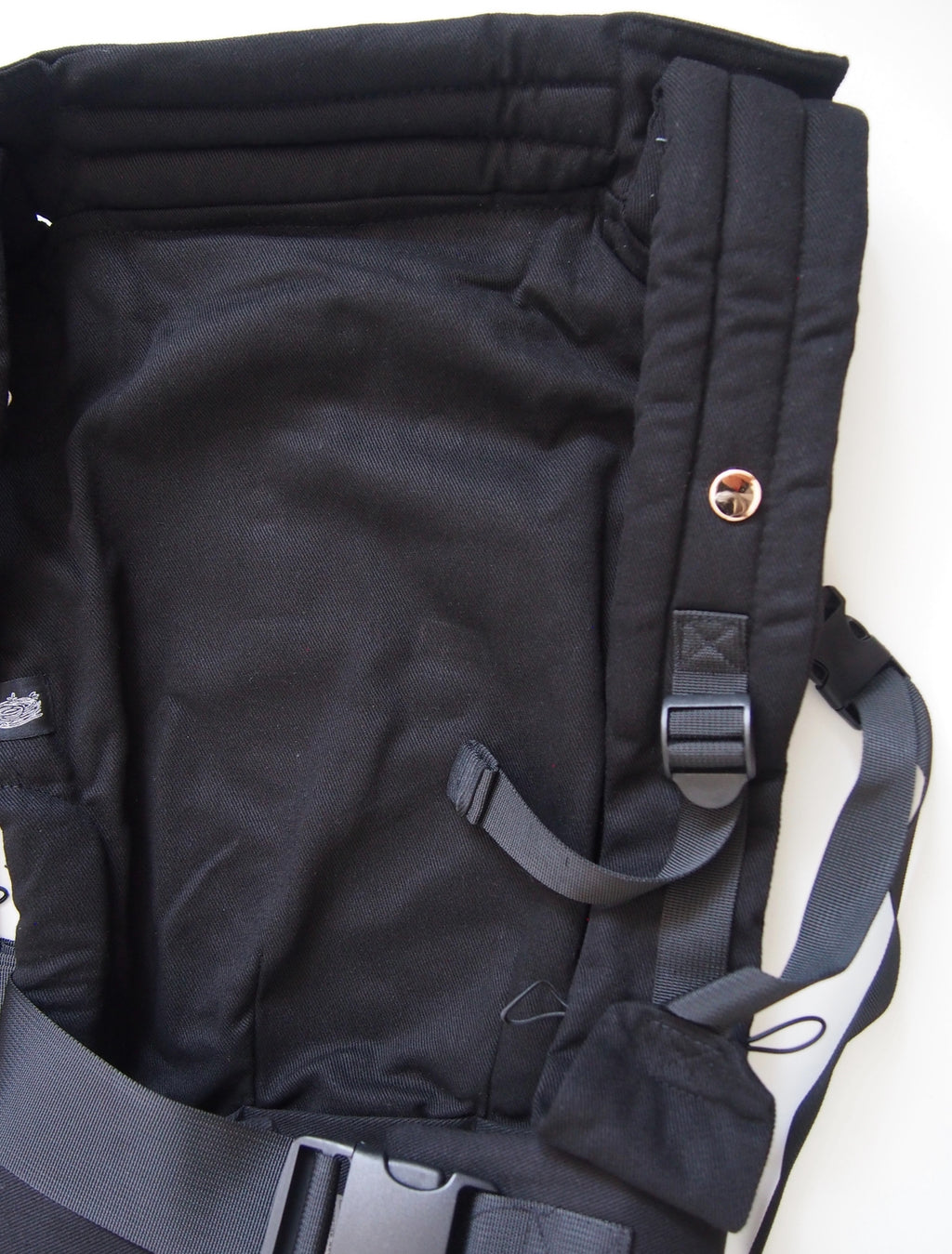 Black ergonomic baby carrier back view - soft-structured carrier with adjustable straps
