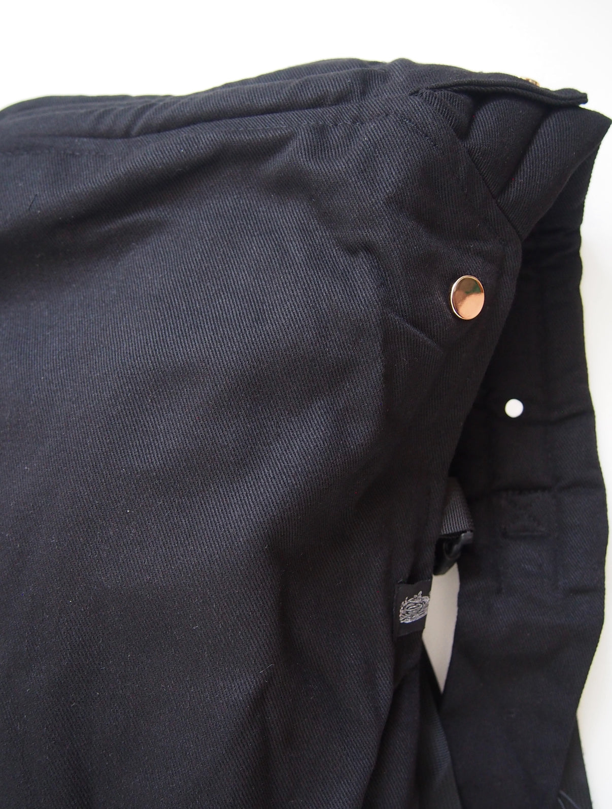 Black ergonomic baby carrier back view - soft-structured carrier with adjustable straps