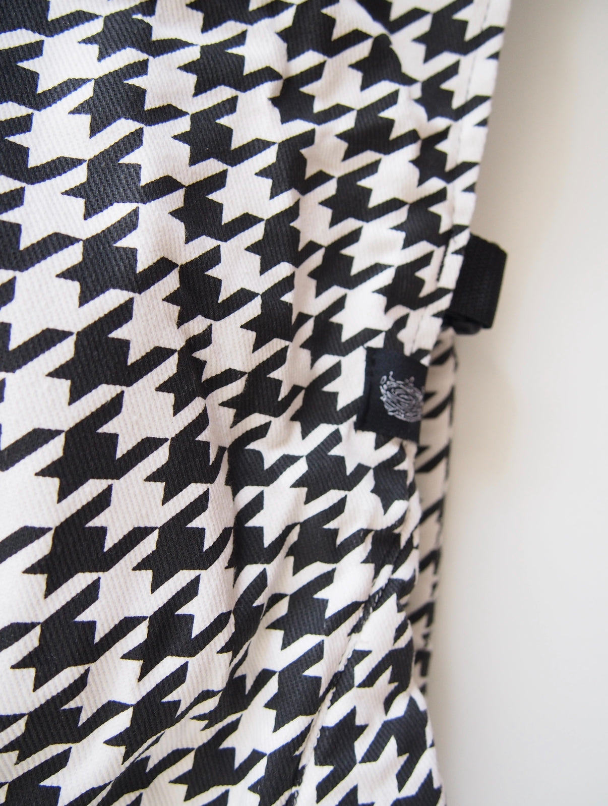 Black houndstooth ergonomic baby carrier back view - soft-structured carrier with adjustable straps