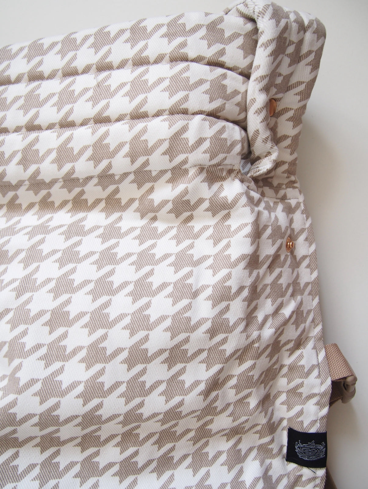 Beige houndstooth ergonomic baby carrier back view - soft-structured carrier with adjustable straps